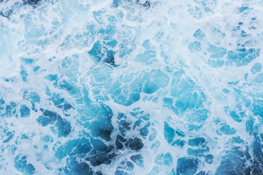 Sea foam over blue water